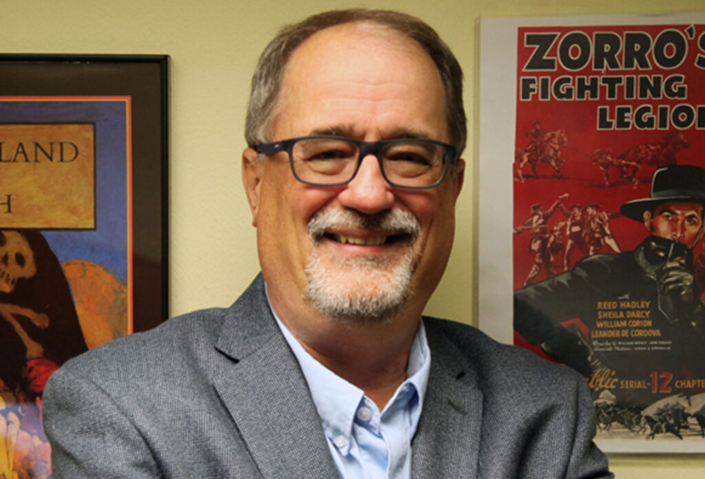 man wearing glasses and gray suit