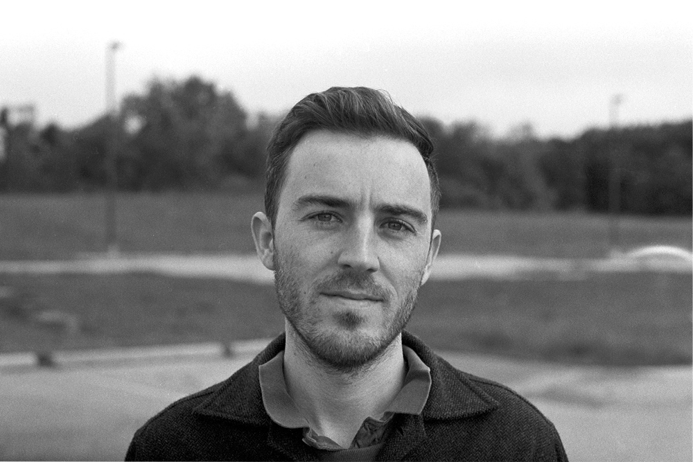 Black and white photo of a man with short hair 