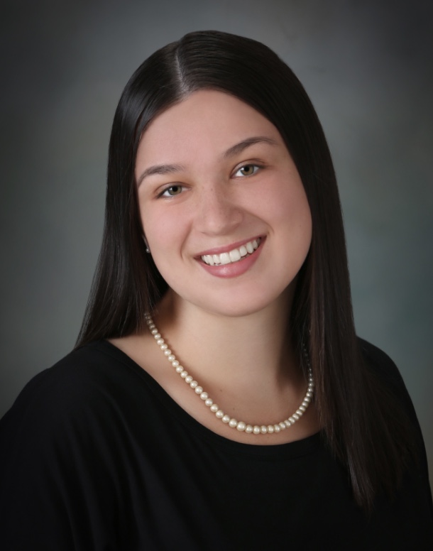 A woman smiling with brown hair for a portrait photo.